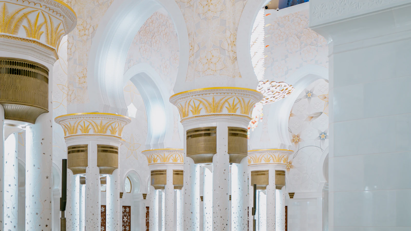 White arches and columns of a mosque, in soft light