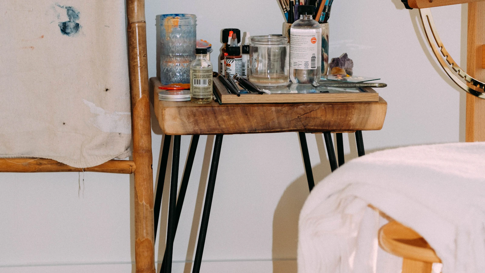 A painter’s studio table with brushes and jars